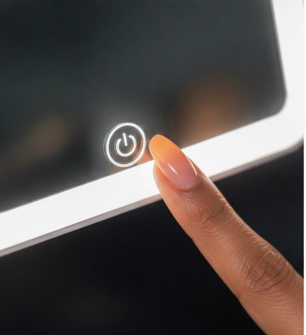 A fingertip touching the power control on Bella